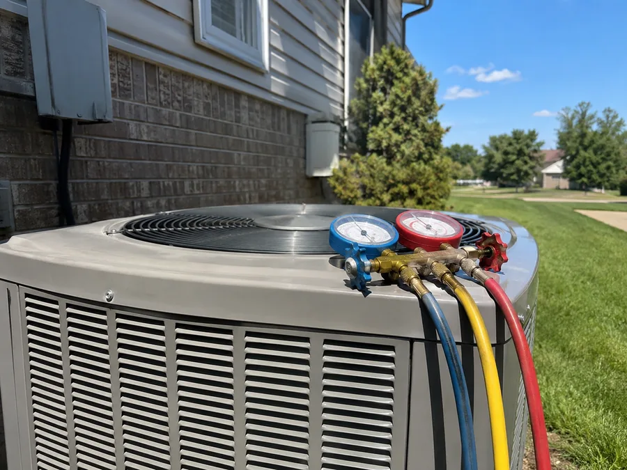 Refrigerant gauges connected to a residential air conditioner during a diagnostic